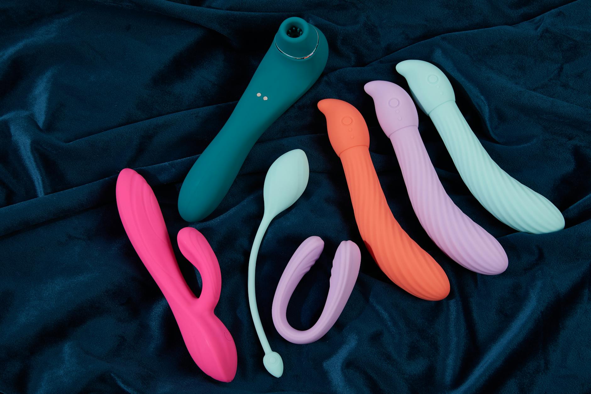 Teal lemon vibrator on white silk fabric