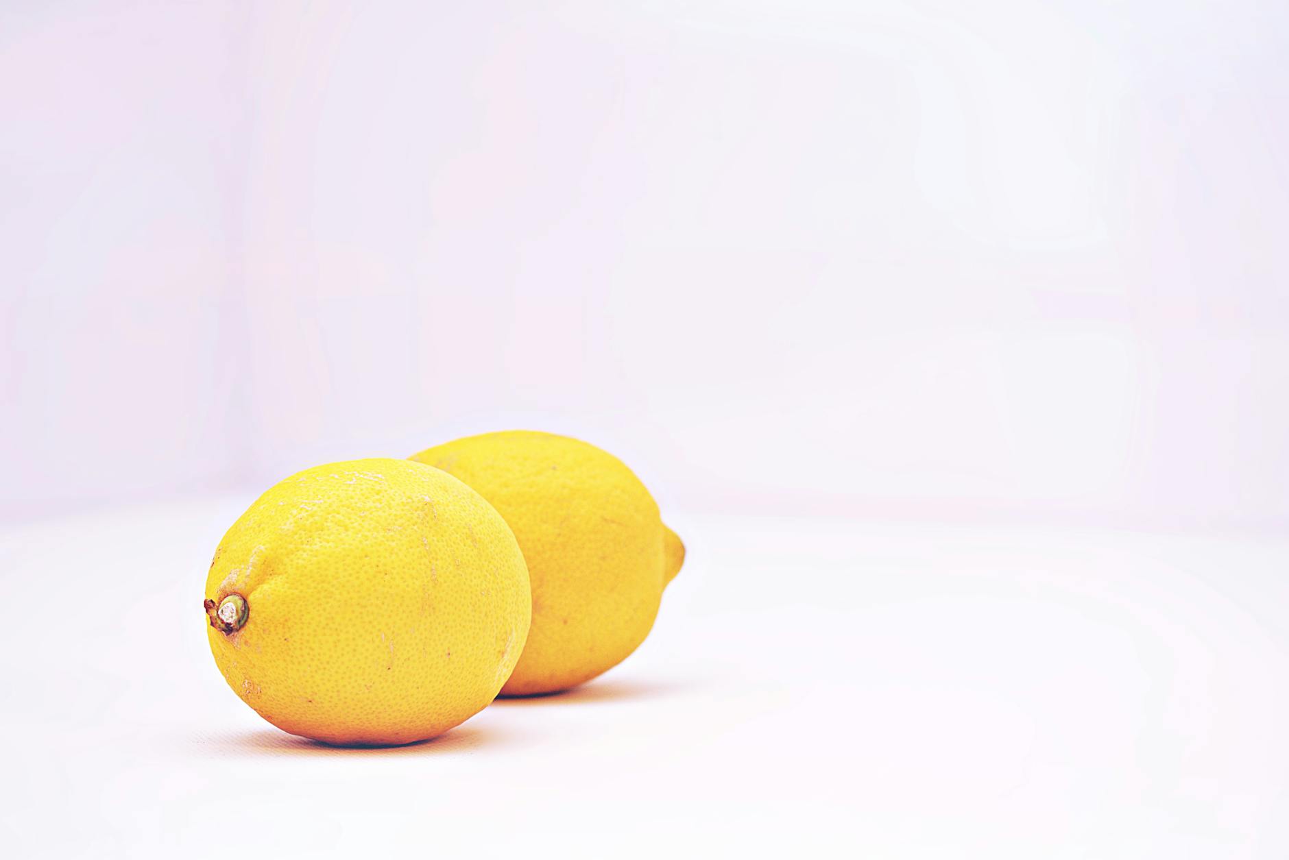 A bright yellow silicone vibrator surrounded by fresh fruit, symbolizing pleasure and natural sensation in intimate relationships.