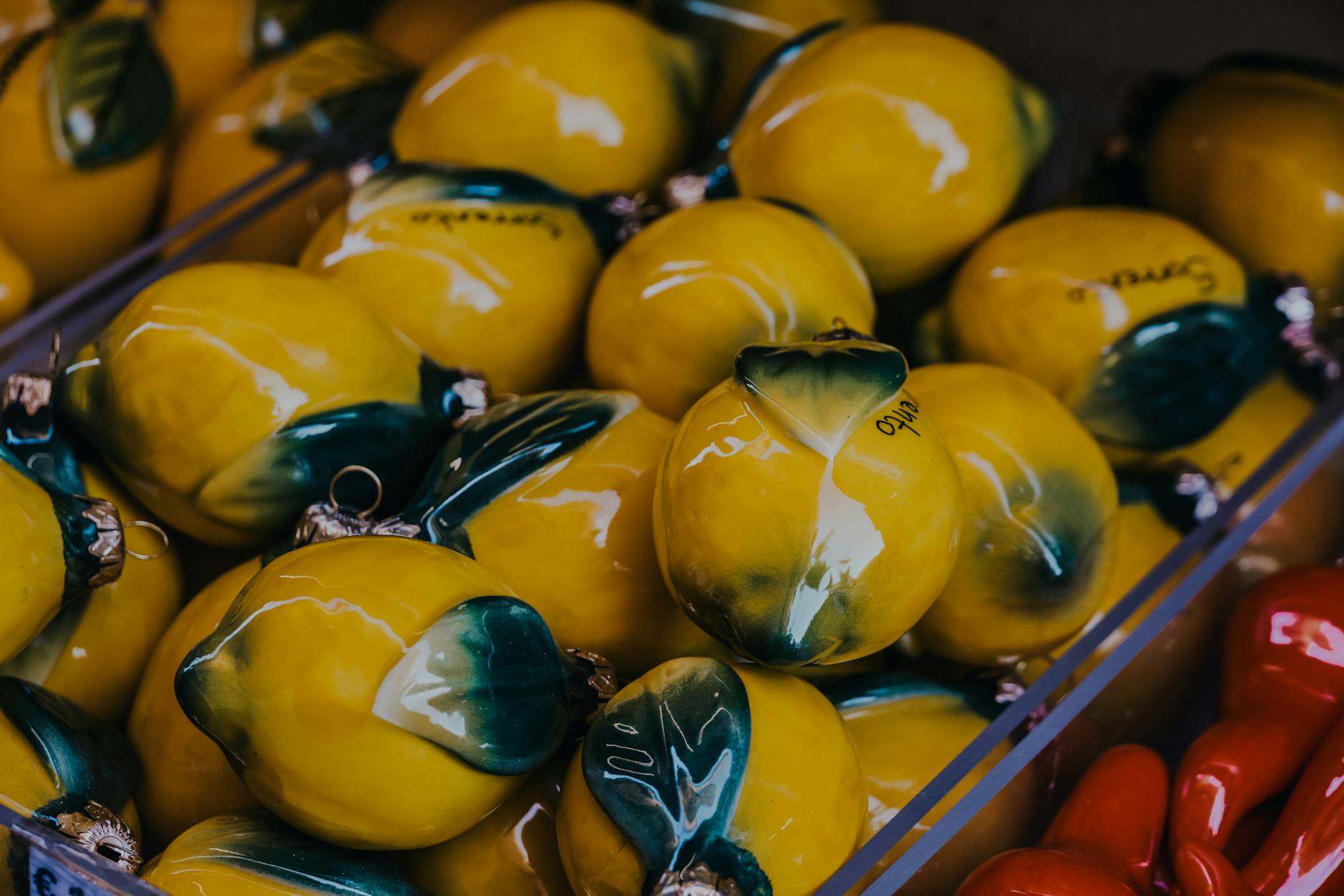 A yellow silicone lemon vibrator surrounded by peeled bananas on a bright yellow background