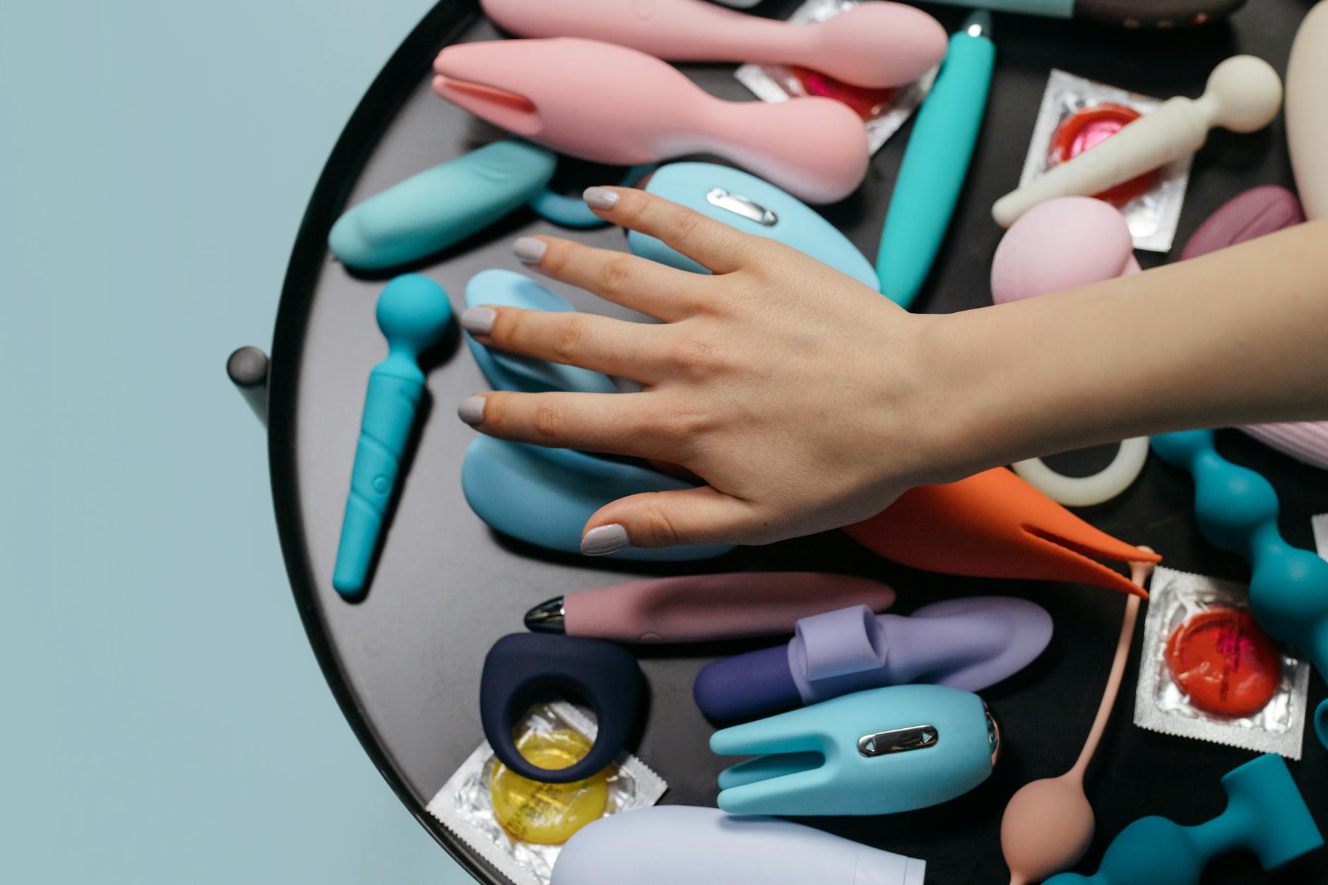 A vibrator surrounded by flowers and citrus on a bright background, symbolizing pleasure and renewal.
