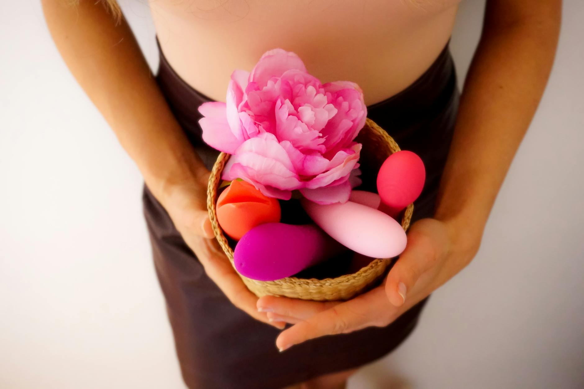 A basket containing colorful vibrators and personal pleasure devices